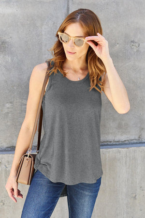 a woman wearing sunglasses and a tank top