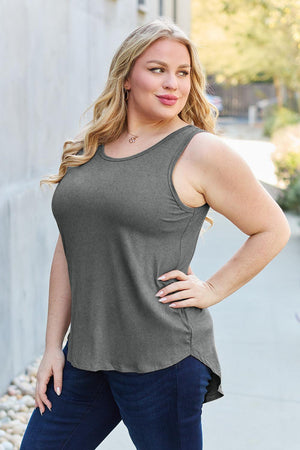a woman posing for a picture while wearing a tank top