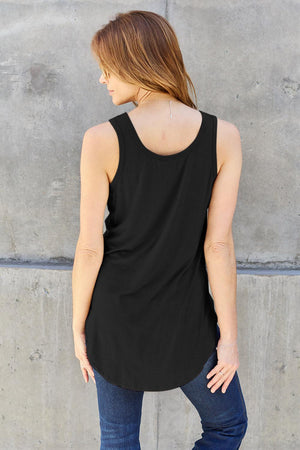 a woman standing in front of a concrete wall