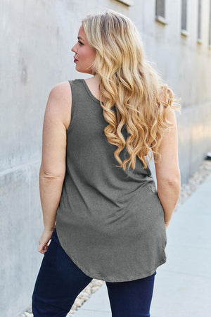 a woman standing on a sidewalk with her back to the camera