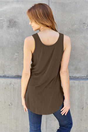 a woman standing against a wall with her back to the camera