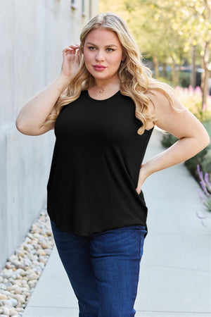 a woman wearing a black top and jeans