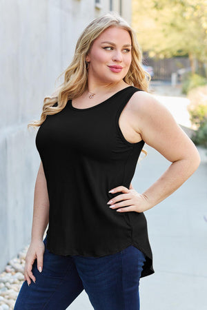 a woman posing for a picture in a black top