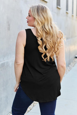 a woman wearing a black top and jeans
