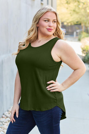 a woman in a green top posing for a picture