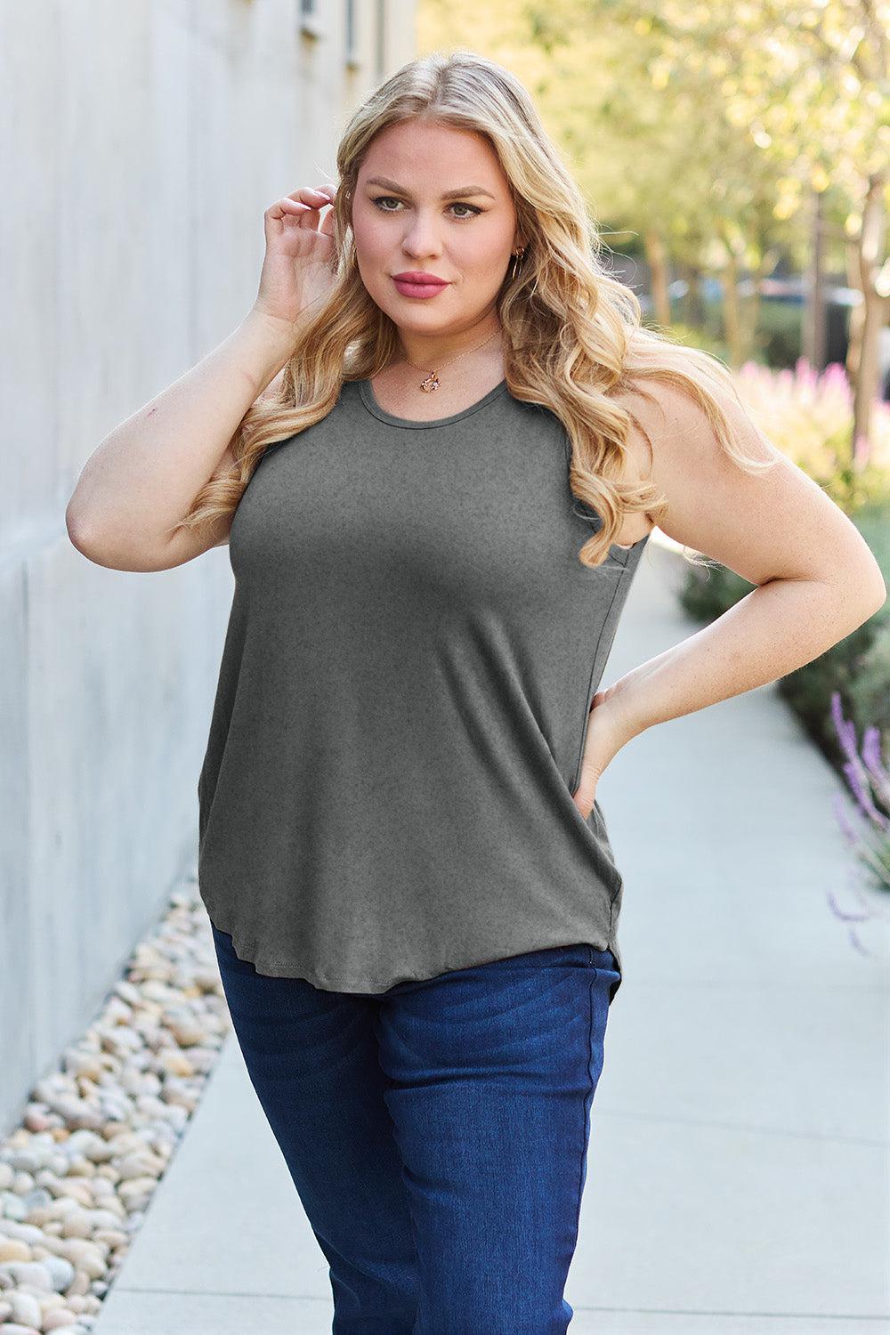 a woman standing on a sidewalk with her hands on her hips