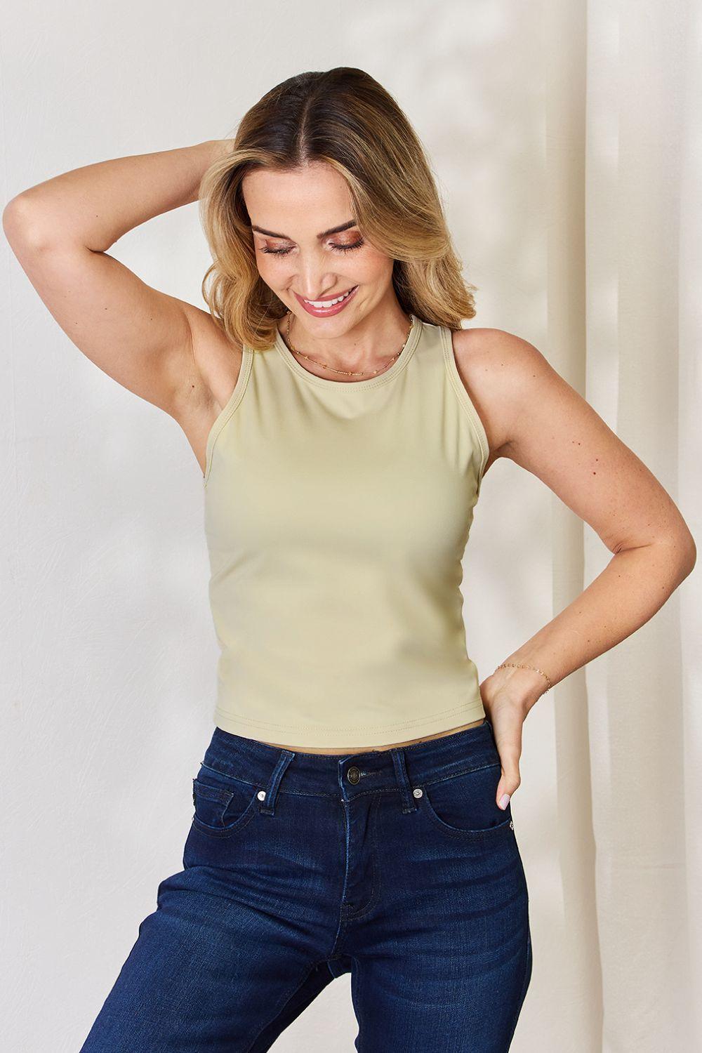 a woman in a tank top is posing for a picture
