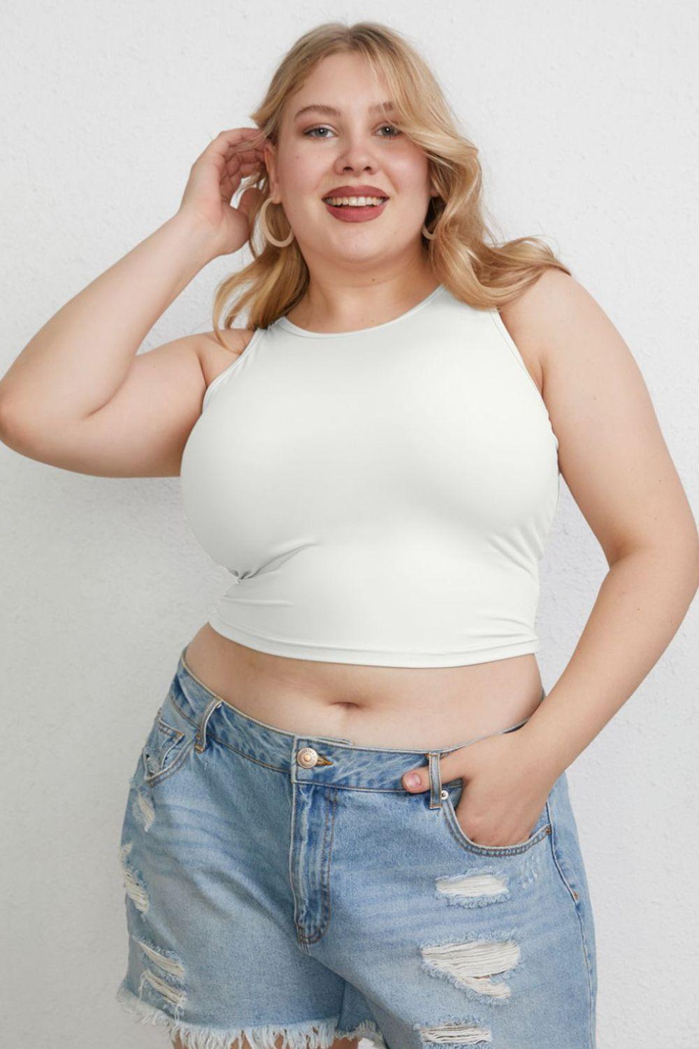 a woman in a white top and ripped jeans