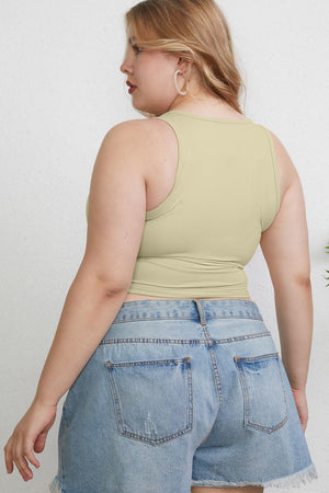 a woman in high waisted shorts and a tank top