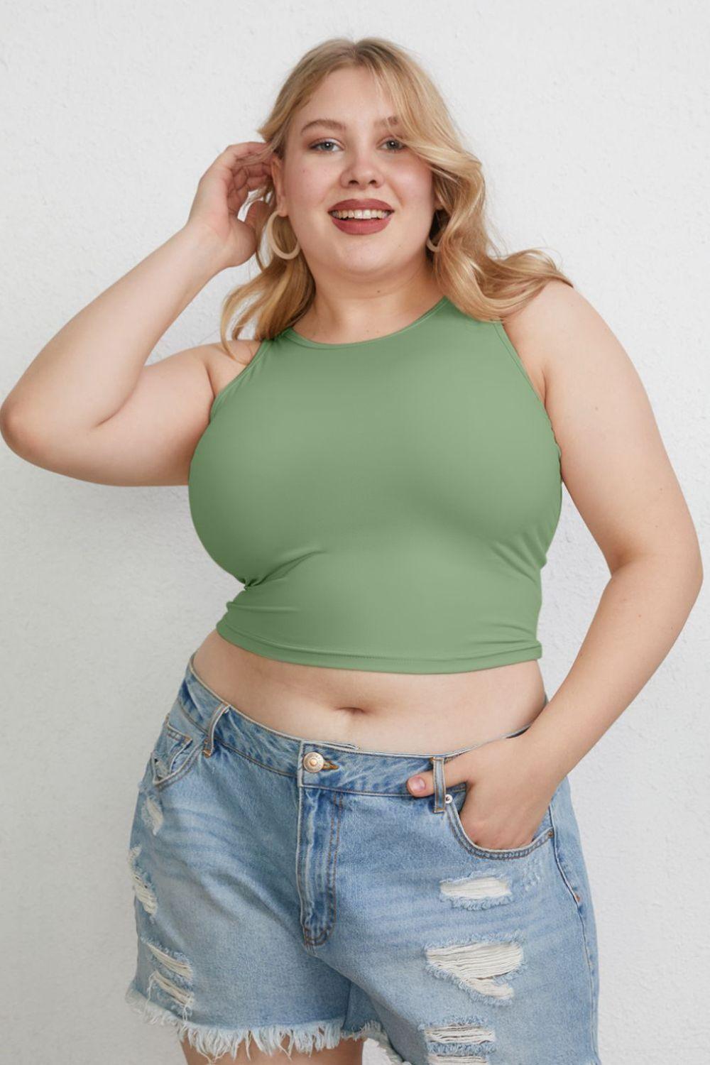 a woman in a green top posing for a picture