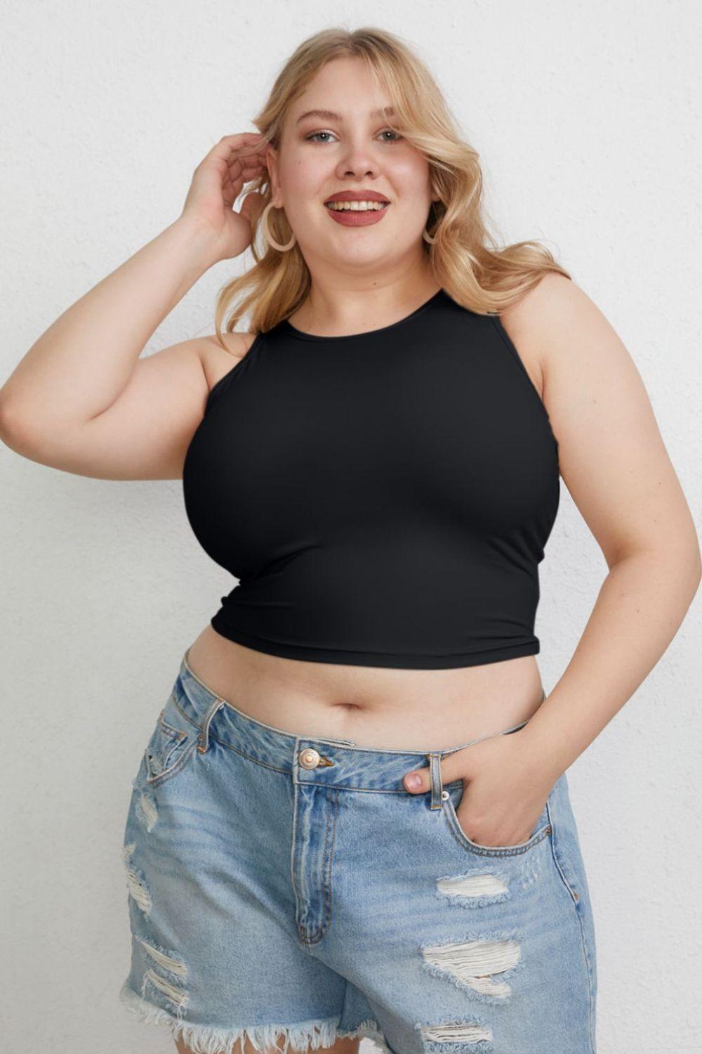 a woman in a black top and ripped jeans