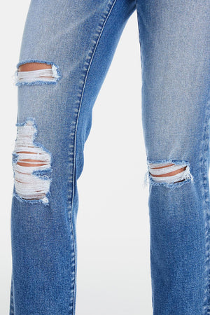 a pair of blue jeans with torn knees