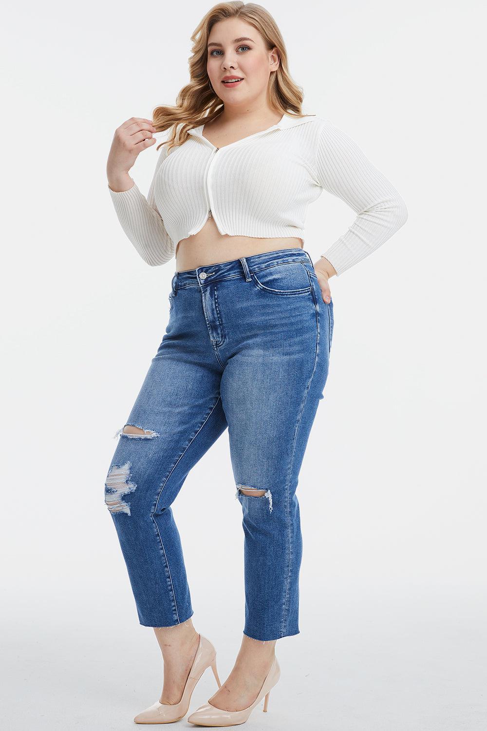 a woman in a white top and ripped jeans