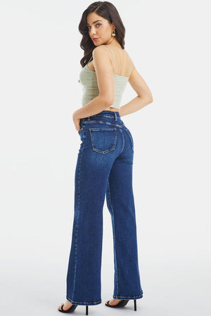 a woman wearing high rise jeans and a tank top