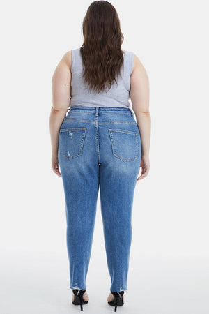 a woman in high rise jeans is facing away from the camera