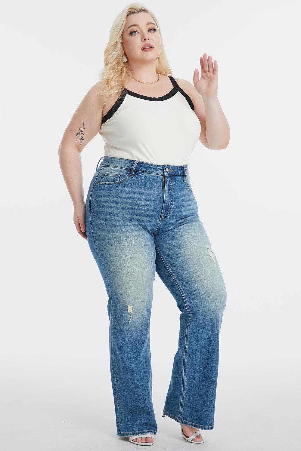 a woman in a white tank top and blue jeans