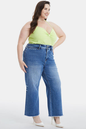 a woman in a yellow top and blue jeans