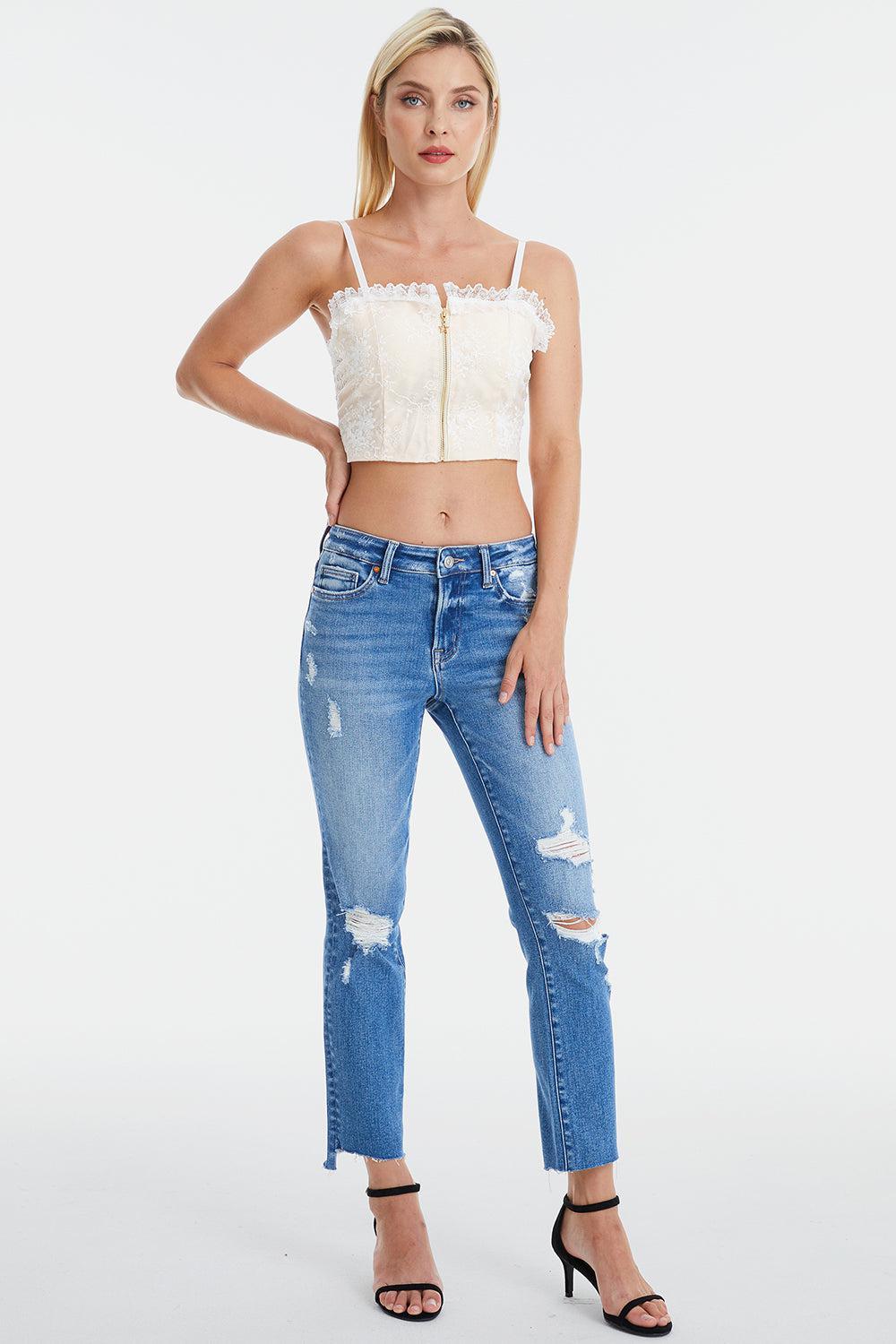 a woman wearing a crop top and jeans