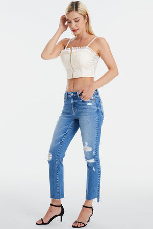 a woman in ripped jeans and a crop top