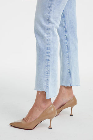 a woman's legs wearing high heels and jeans