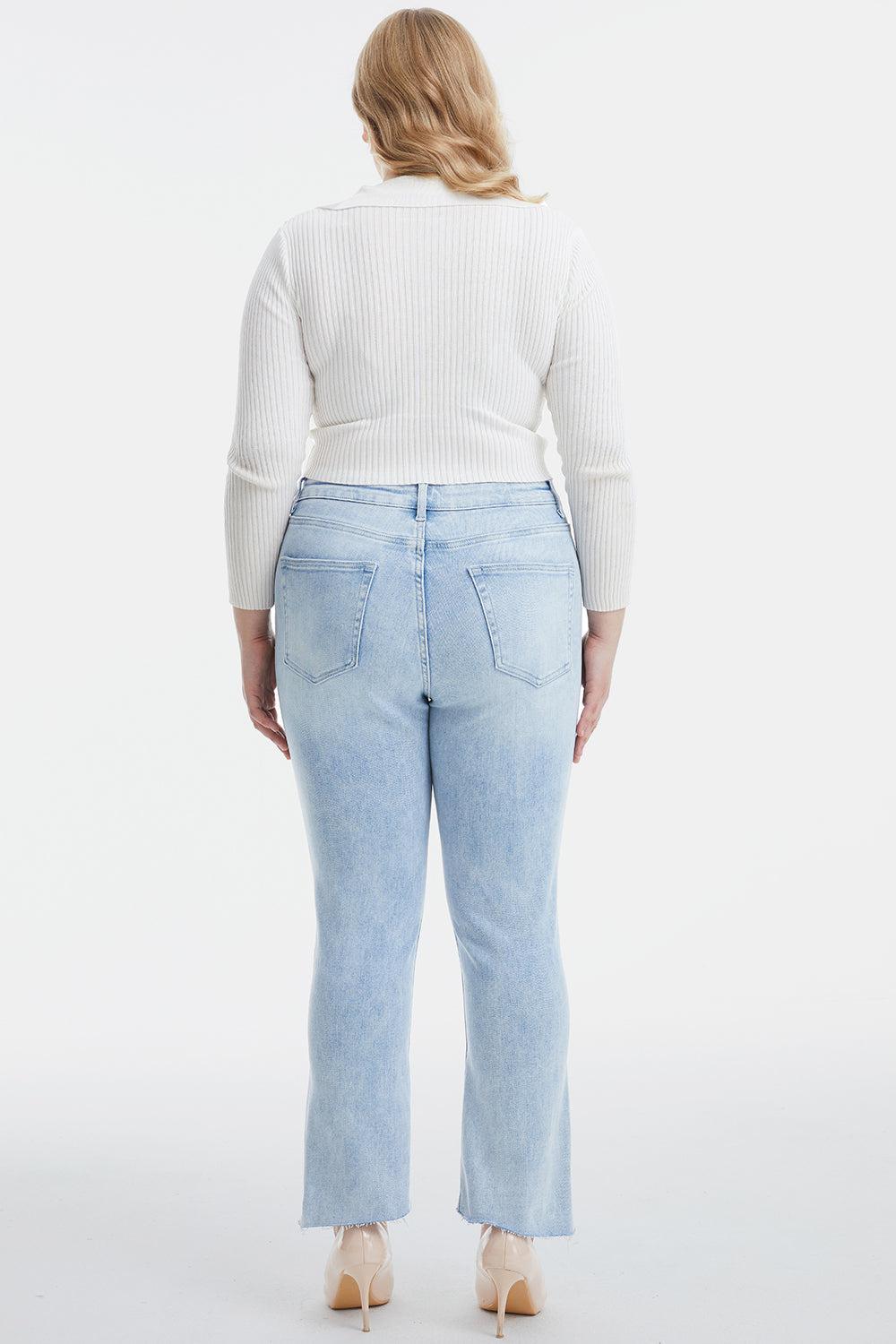 a woman in a white sweater and light blue jeans