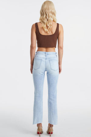 a woman in high rise jeans and a crop top