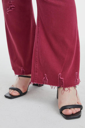 a woman's feet in a pair of red jeans