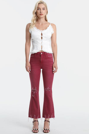 a woman in a white top and red jeans