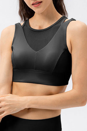 a woman wearing a black sports bra top