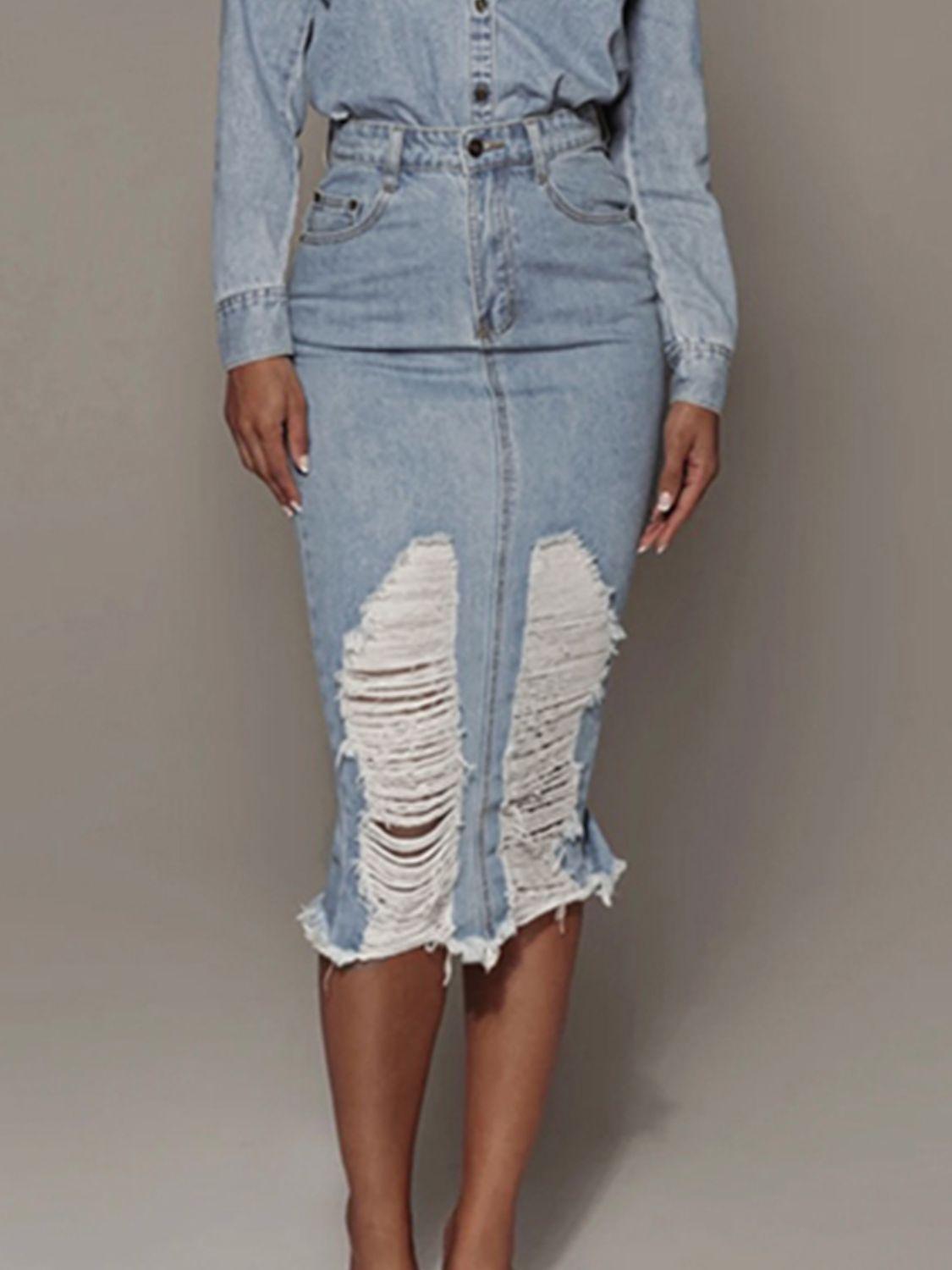 a woman in a denim dress with ripped knees
