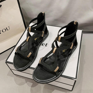 a pair of black sandals sitting on top of a box