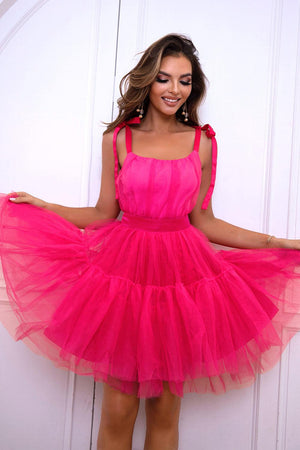 a woman in a pink dress posing for a picture