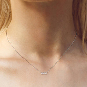 a close up of a woman wearing a necklace