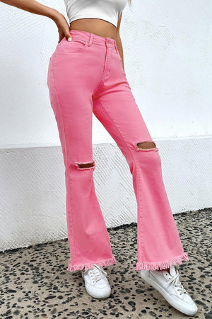 a woman in a white shirt and pink jeans