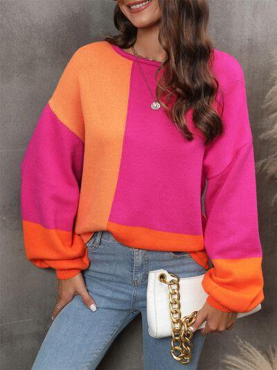 a woman wearing a colorful sweater and jeans