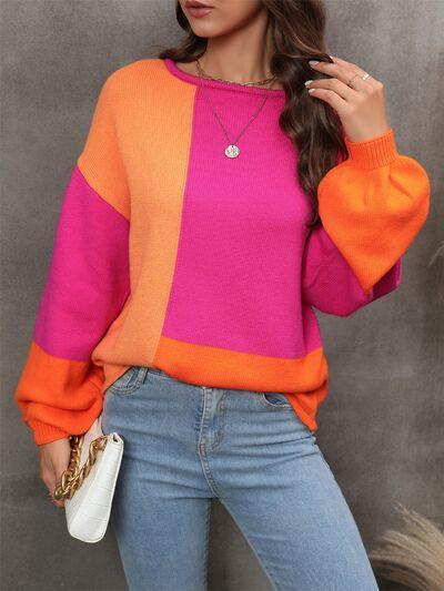 a woman wearing a pink and orange sweater