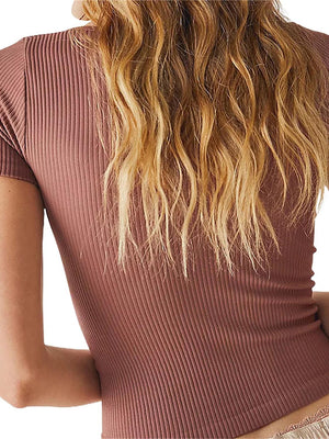 a woman wearing a short sleeved top