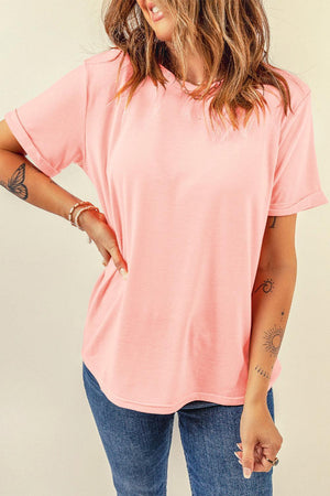 a woman wearing a pink shirt and jeans