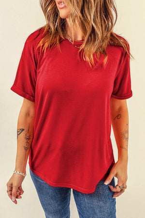a woman wearing a red shirt and jeans