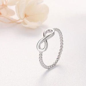 a silver ring with an infinite sign on it