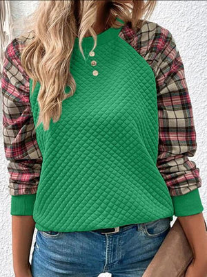 a woman wearing a green sweater and jeans