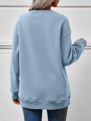 a woman wearing a blue sweatshirt and jeans