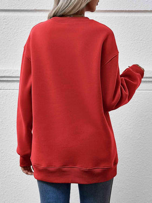 a woman wearing a red sweatshirt and jeans