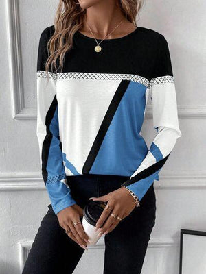 a woman wearing a black, white and blue top