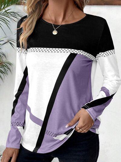 a woman wearing a black, white and purple top