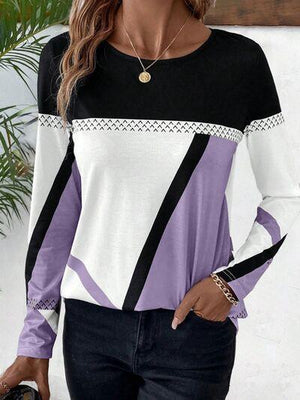 a woman wearing a black, white and purple top
