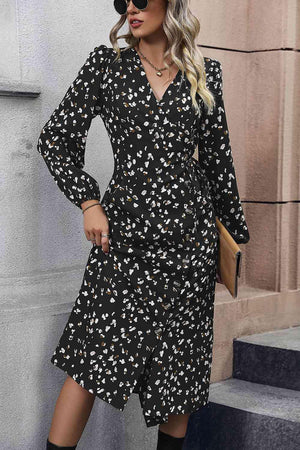 a woman wearing a black and white floral print dress