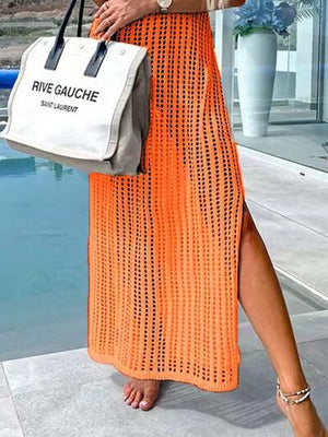 a woman in an orange dress holding a white bag
