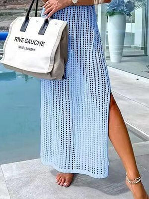 a woman in a blue dress holding a white bag