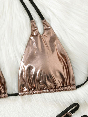 a pair of shiny bras laying on top of a white fur